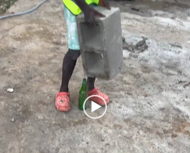 qoqwz Man making a block stand on a bottle