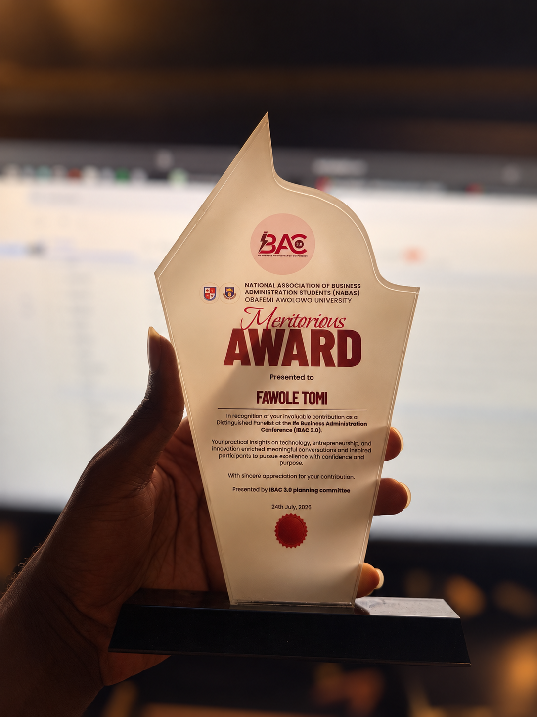  Fawole Tomi receives a Meritorious Award in recognition of his contribution as a distinguished panelist at IBAC 3.0